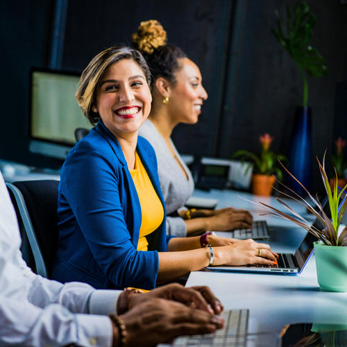 Diverse group of people working together in a modern office setting.